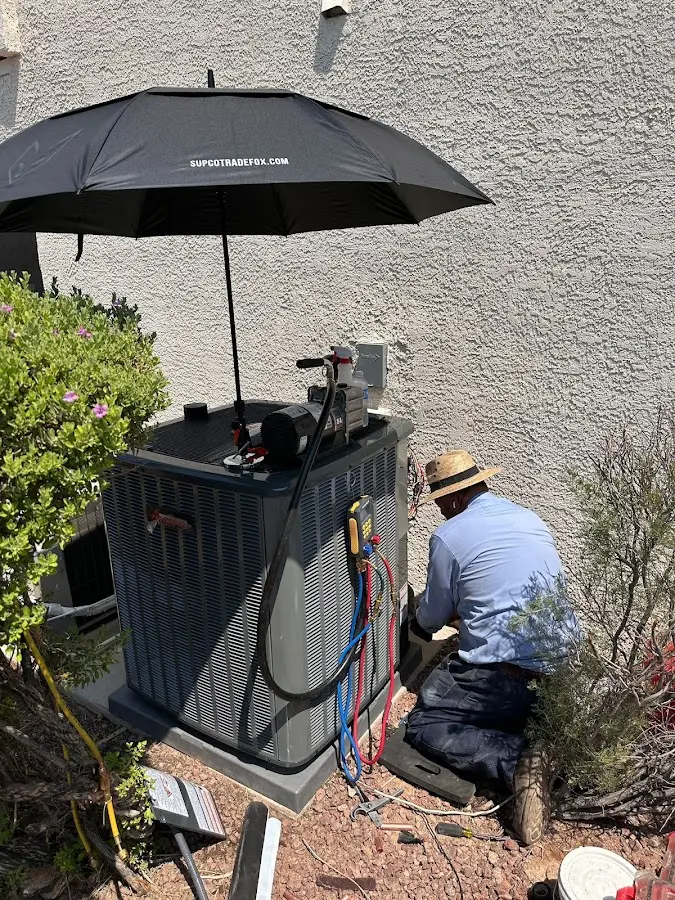 HVAC technician performing outdoor AC maintenance in Moosic